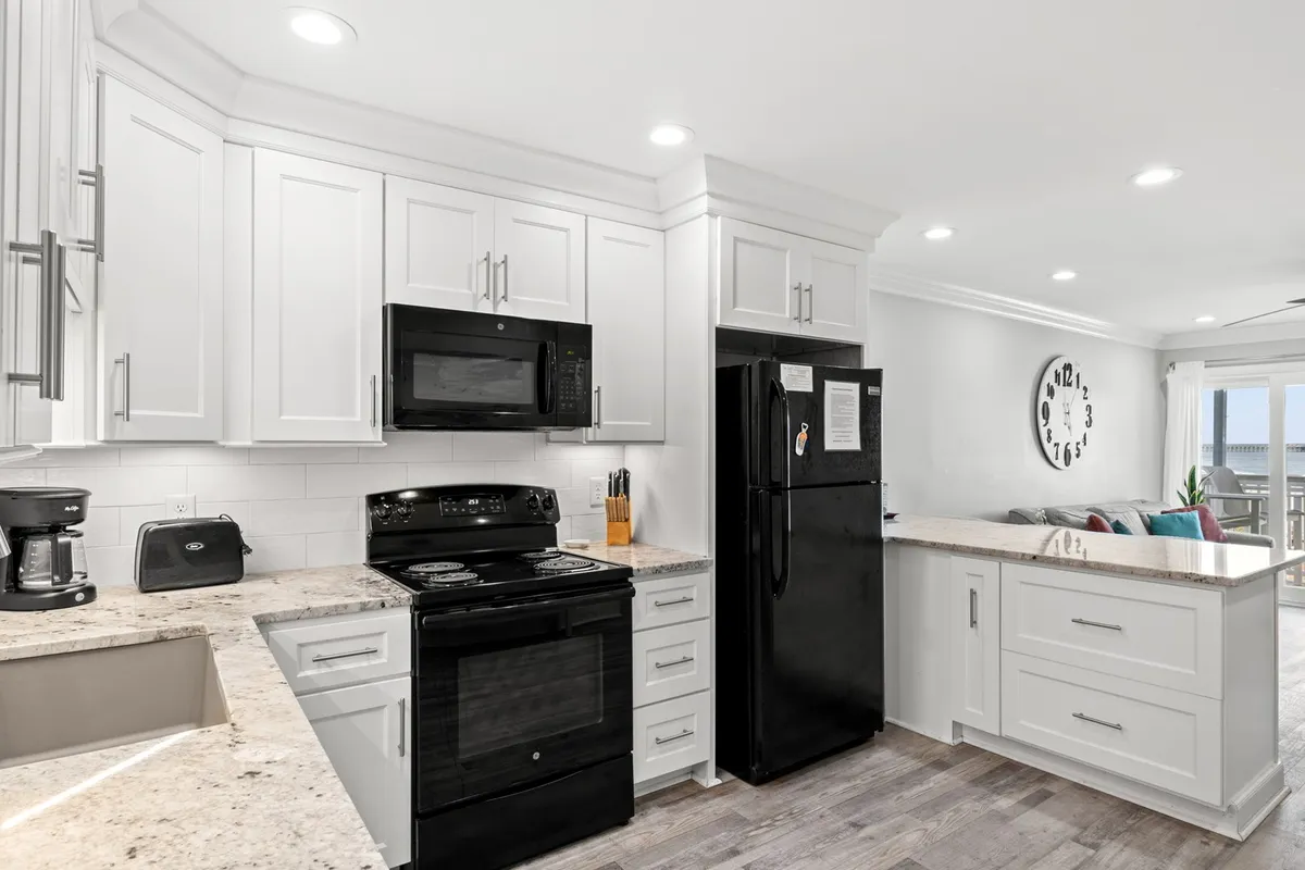 A modern, well-lit kitchen with granite countertops, sleek appliances, and an open layout that connects to the rest of the living space. The scene suggests readiness for both casual breakfasts and celebratory family feasts.